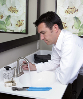 Hayward plumbing technician repairs a stainless steel bathroom sink